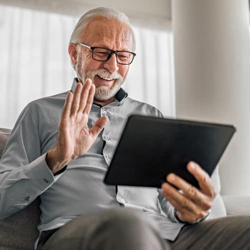 senior man using social media on tablet