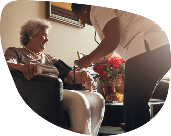 Elderly woman getting blood pressure taken at retirement community; assisted living, independent living, skilled nursing