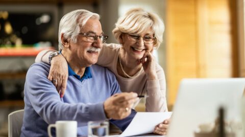 Happy mature couple using laptop while planning their home budget. 2026 Tax Savings for South Carolina Seniors
