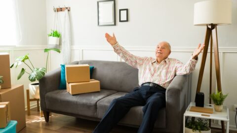 Happy old senior man relaxing and enjoying his new apartment The Benefits of Choosing a Smaller Apartment in Retirement